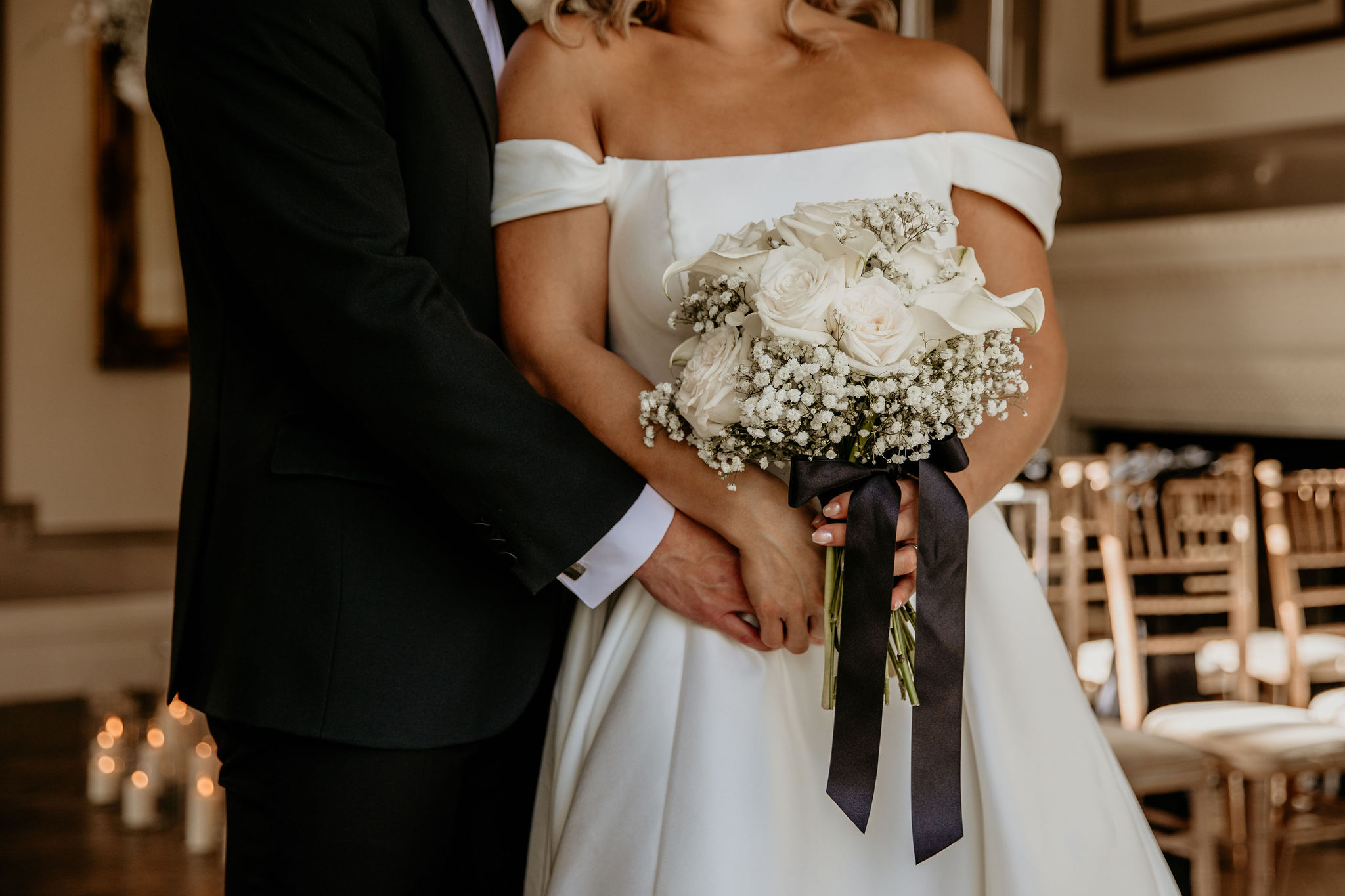 A couple embracing with the bridal bouquet