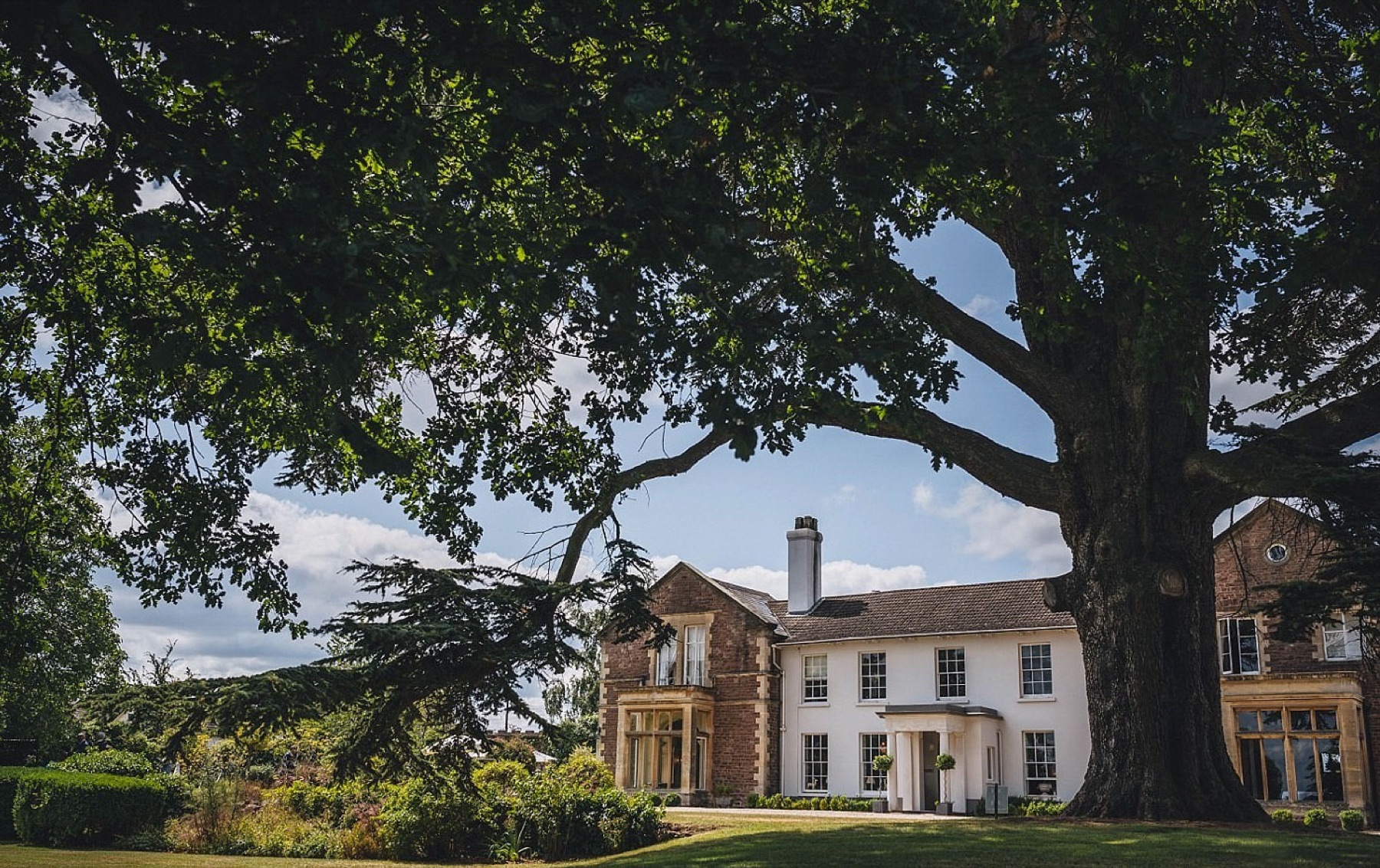The Glewstone Court manor, framed by the 500-year-old Cedar of Lebanon on the south lawn